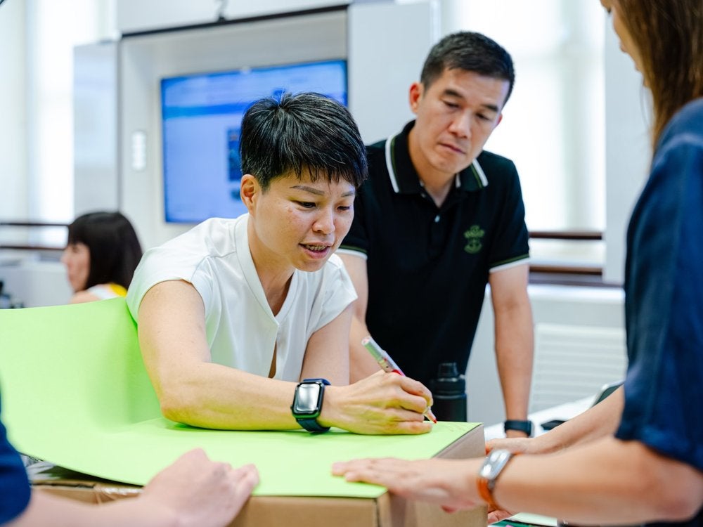 Participants collaborating on a hands-on workshop exercise at LKYSPP